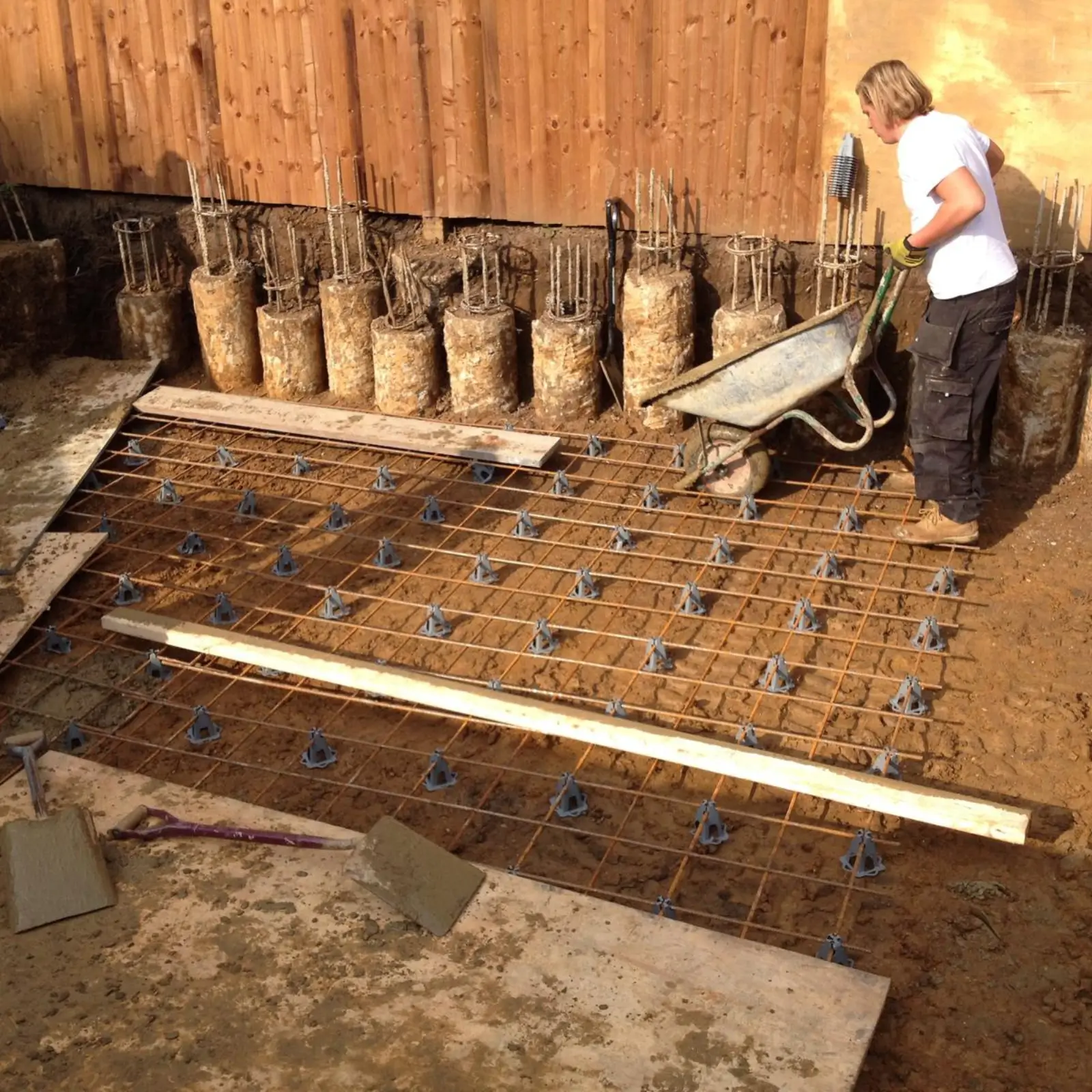 Groundwork team prepares a foundation with a rebar grid.