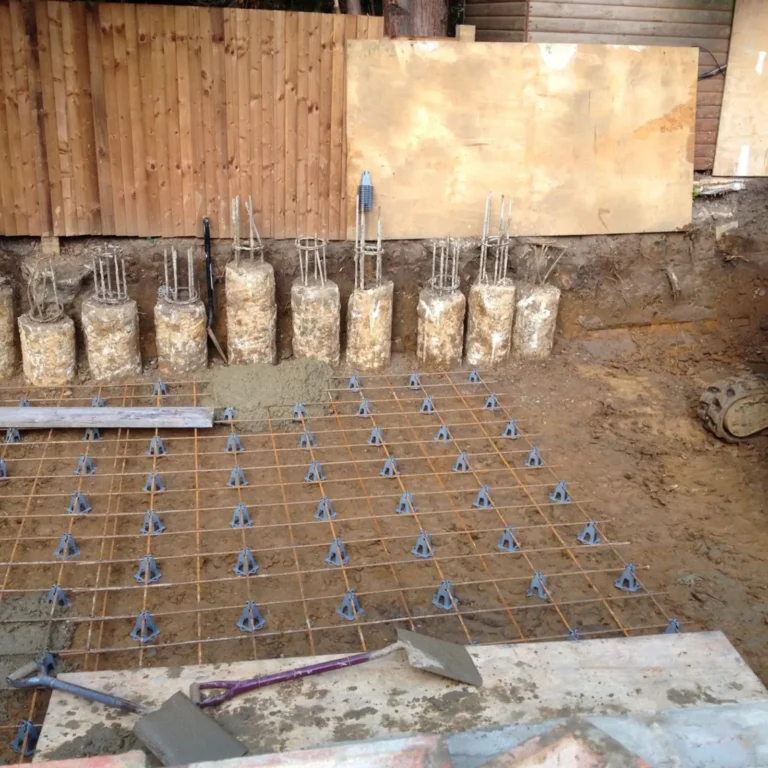 Rebar and concrete piles for a partial basement foundation.