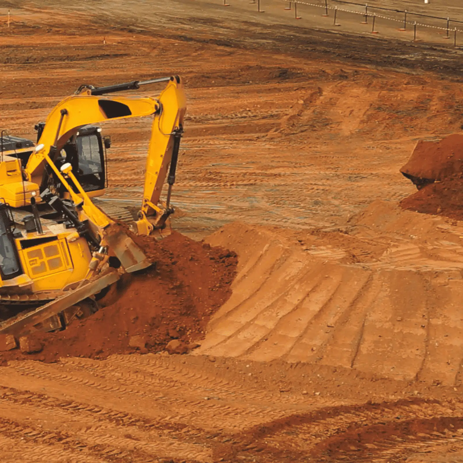Excavator digs soil for a permeability test.