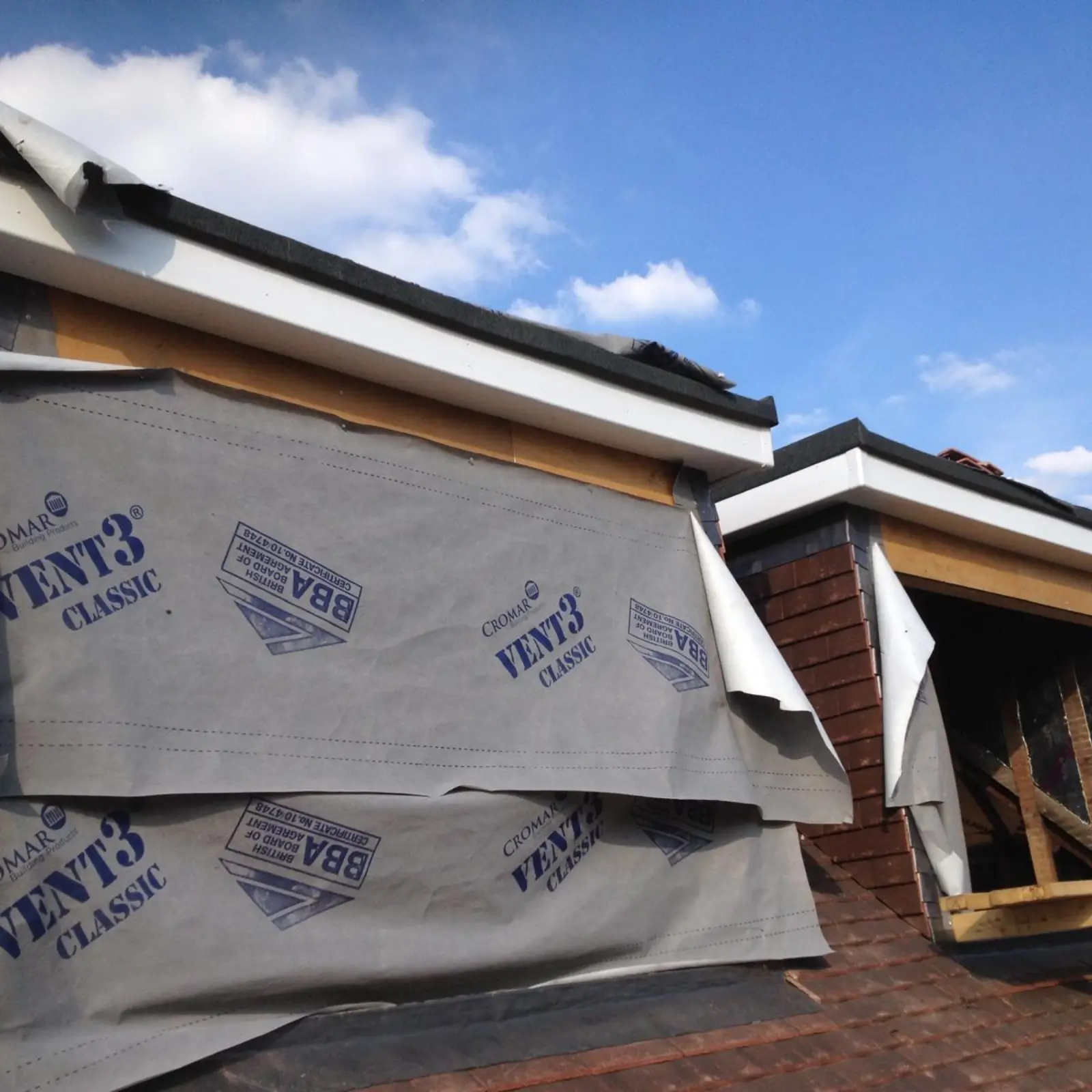 Building wrapped in a protective membrane in Bushey.