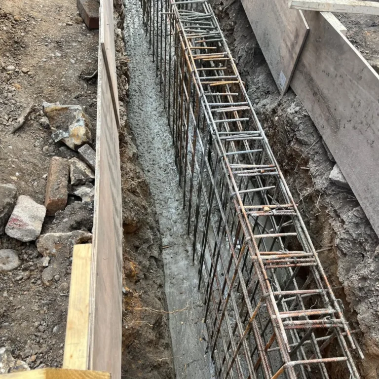 Rebar cage in a narrow trench for a mini piling foundation.