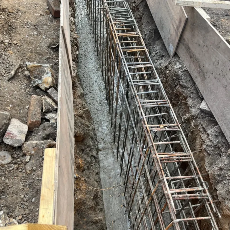 Rebar cage in a narrow trench for a mini piling foundation.