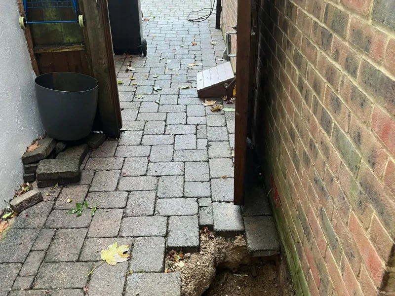 Paving removed for mini piling on a limited access site.