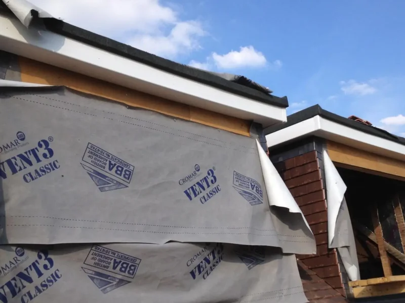 Building wrapped in a protective membrane in Bushey.